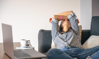 Woman experiencing fatigue and burnout while working from home, representing low energy, mental exhaustion, and healthy lifestyle challenges.