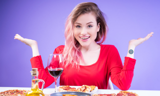 Woman feeling hungry while sitting in front of food, illustrating constant hunger, cravings and appetite control challenges.