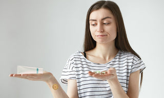 Woman comparing collagen cream and supplements, deciding between creams, pills, or collagen patches for skin health