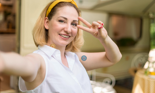 Woman wearing two wellness patches on her neck and upper arm, demonstrating how multiple wellness patches can be worn at the same time.