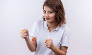 Woman wearing an energy patch on her arm, showing support for daily energy, focus, and wellness.