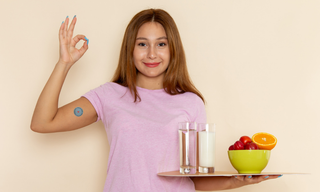 Woman wearing an appetite control patch on her arm, holding a tray with water, milk, and fruits, showing healthy lifestyle choices.