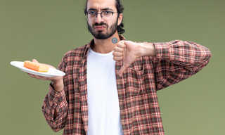Man wearing a hunger control patch rejecting cake to support appetite control and healthy weight management.