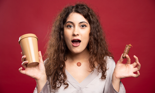 Woman holding a coffee cup and a snack while wearing an energy patch, showing a choice between caffeine and natural energy support.