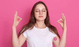 Person meditating with eyes closed and a small patch on the upper arm, representing daytime focus support and nighttime calm for better sleep balance.